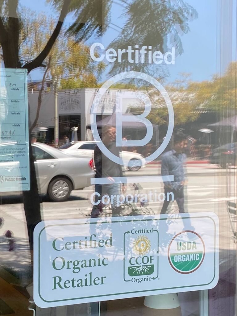 B certified sign at Erewhon entrance door