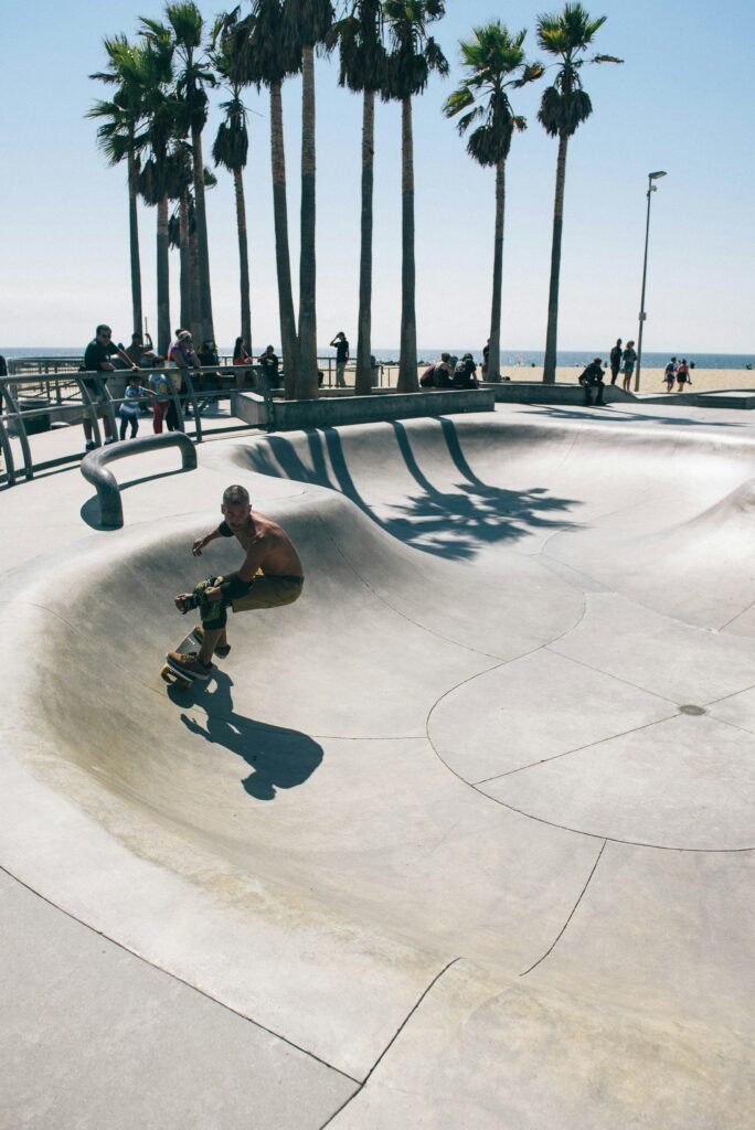 A guy skateboarding at Venice beach skate park